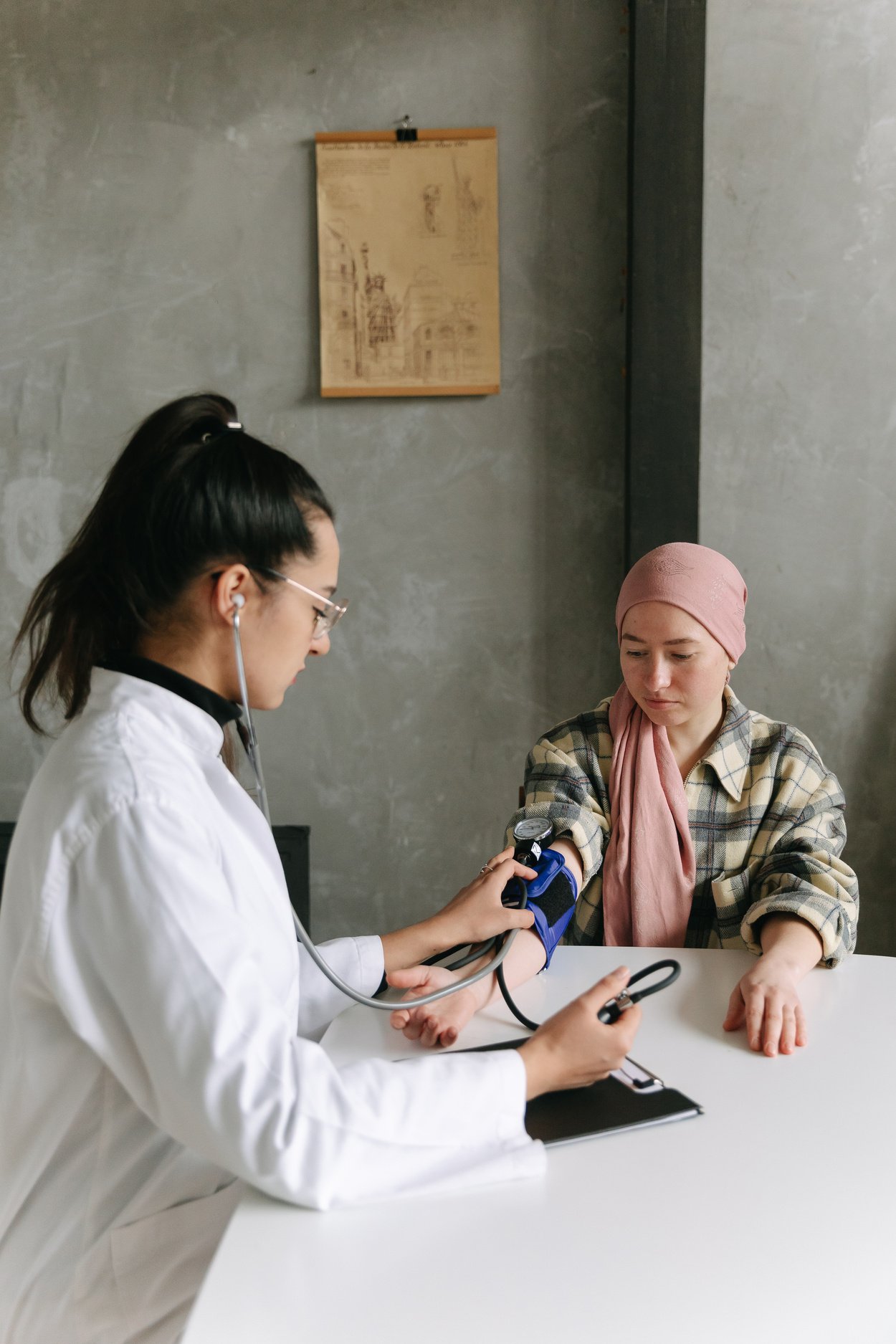 A Man Checking a Woman's Blood Pressure